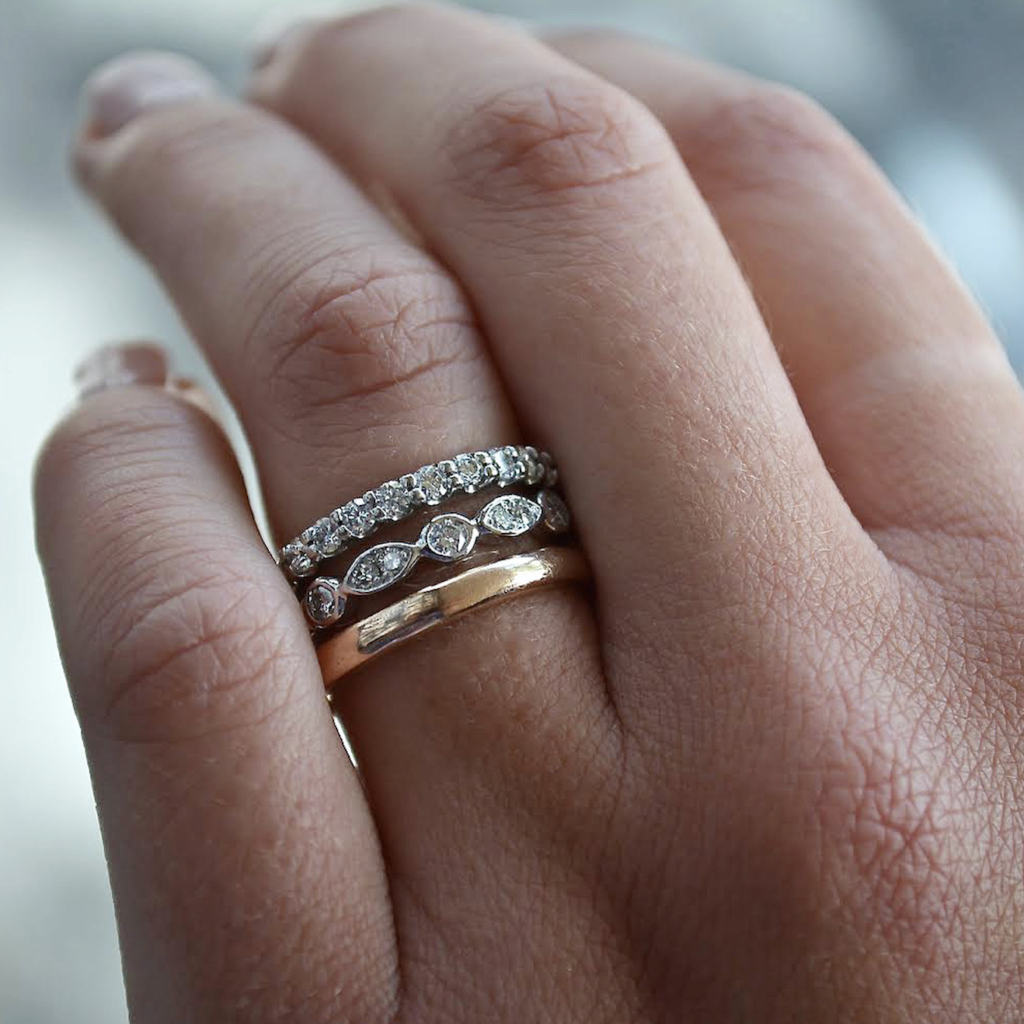 image of a stack wedding rings on a finger